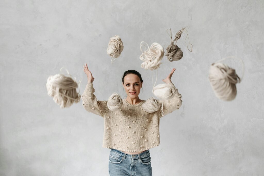 Girl surrounded by floating yarn balls,symbolizing creativity,stress relief,and patience.
