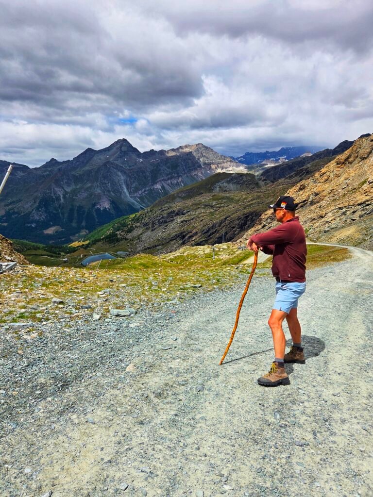 Man standing and admiring a panoramic mountain view.