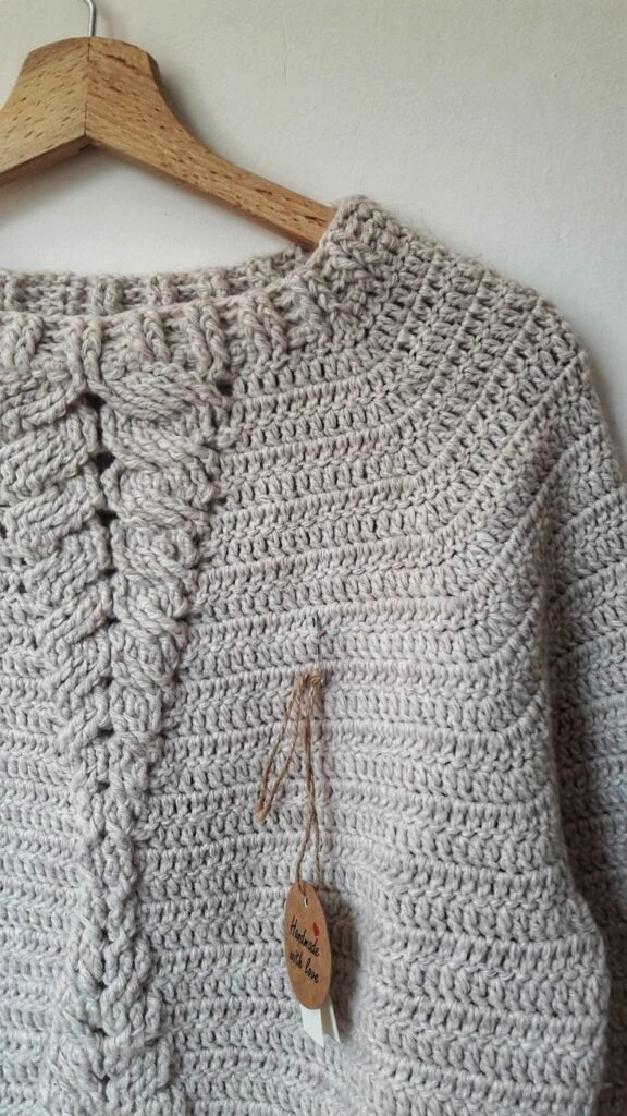 Handmade crochet sweater in chunky natural wool with decorative front cable detail