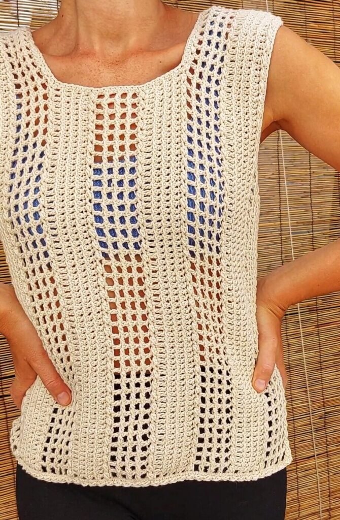 Woman wearing a sleeveless beige crochet mesh t-shirt with vertical lace stripes, handmade summer top