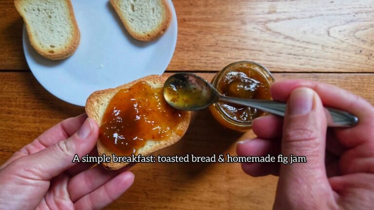Homemade fig jam being spread on a slice of bred, cozy and handmade living.