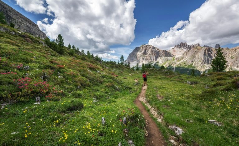 A peaceful mountain path leading toward distant peaks, symbolizing slow living and mindful journeys.
