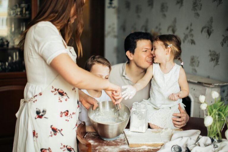 A family of four enjoying slow living moments while baking homemade bread together.